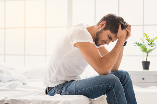 What to Expect from Alcohol Detox, detox from alcohol - young man sitting on bed - willingway