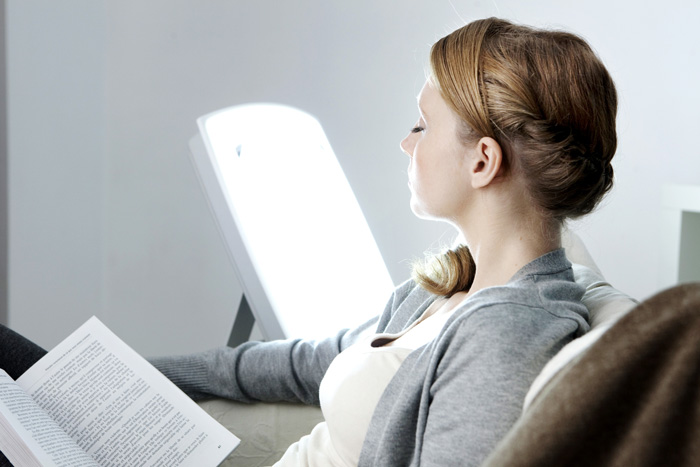 Understanding-How-SAD-May-Affect-Your-Mood - woman using light therapy lamp